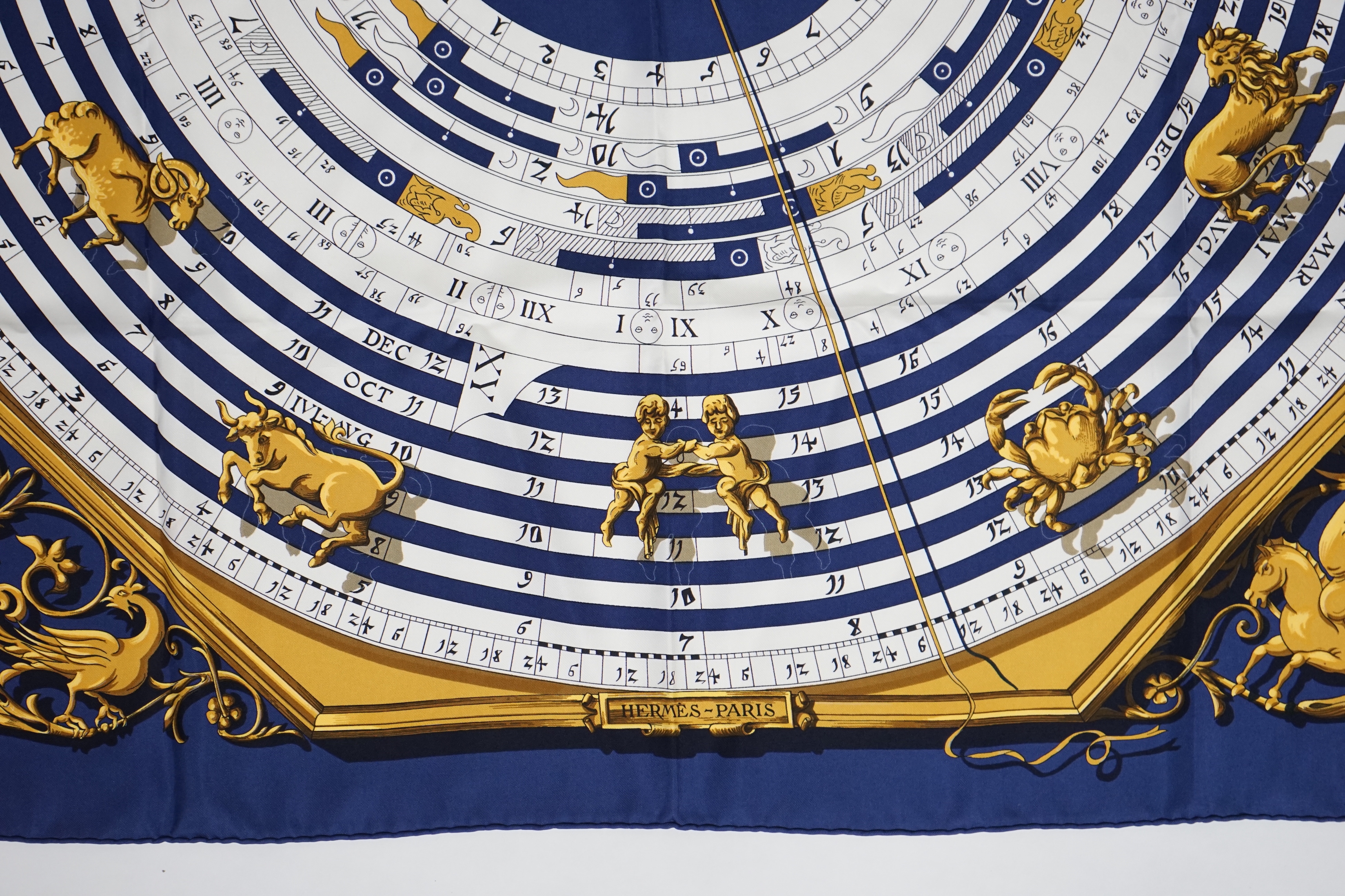 A Hermès Dies et Hore navy silk scarf, 90cm x 90cm
